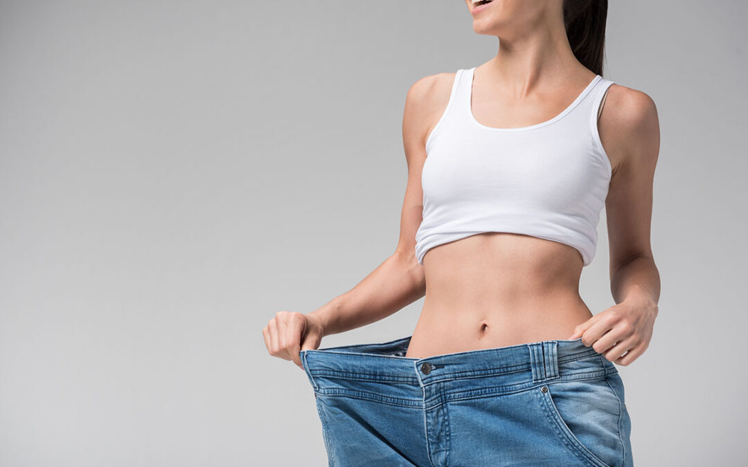 Joyful slim girl showing result of diet