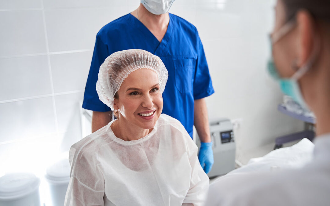 Woman laughing and looking at the nurse while waiting for the procedure