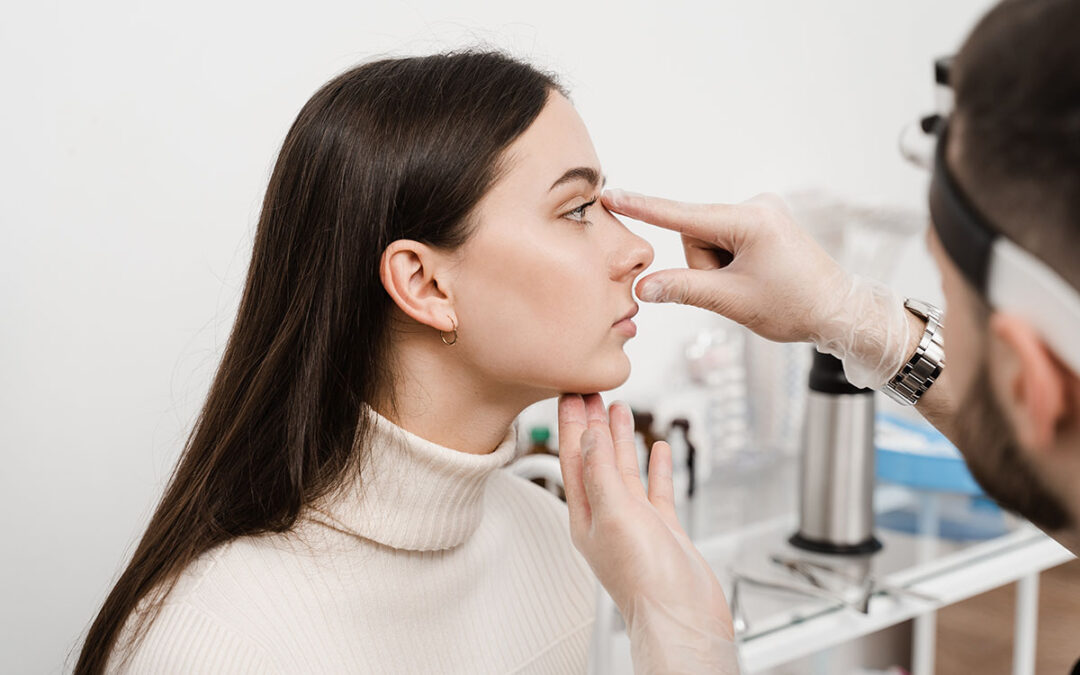 Surgeon is touching and examining patient's nose