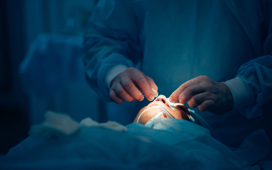 Surgeon wearing gloves operates women's nose