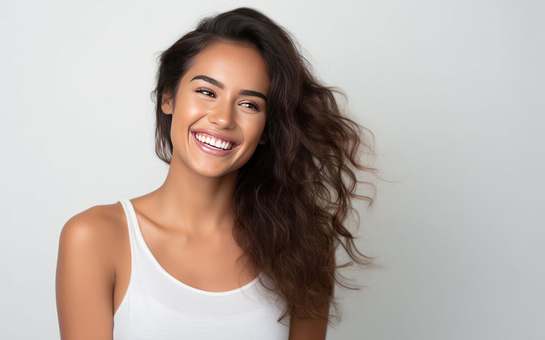 Closeup photo portrait of a beautiful young latin hispanic model woman smiling with clean teeth