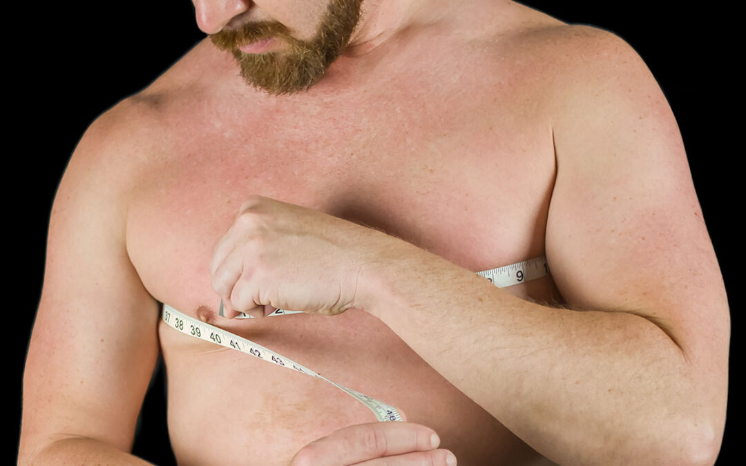 Man measuring his chest with measuring tape to see muscle gain or weight loss of body fat percentage