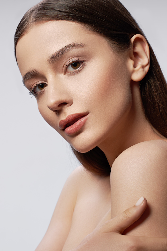 two beautiful woman with their heads on one another